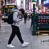 Teenager Walking With Head Down on Phone in Times Square